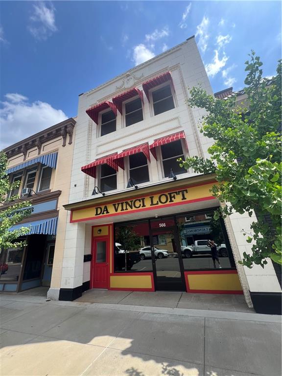 a front view of house with yard and swimming pool