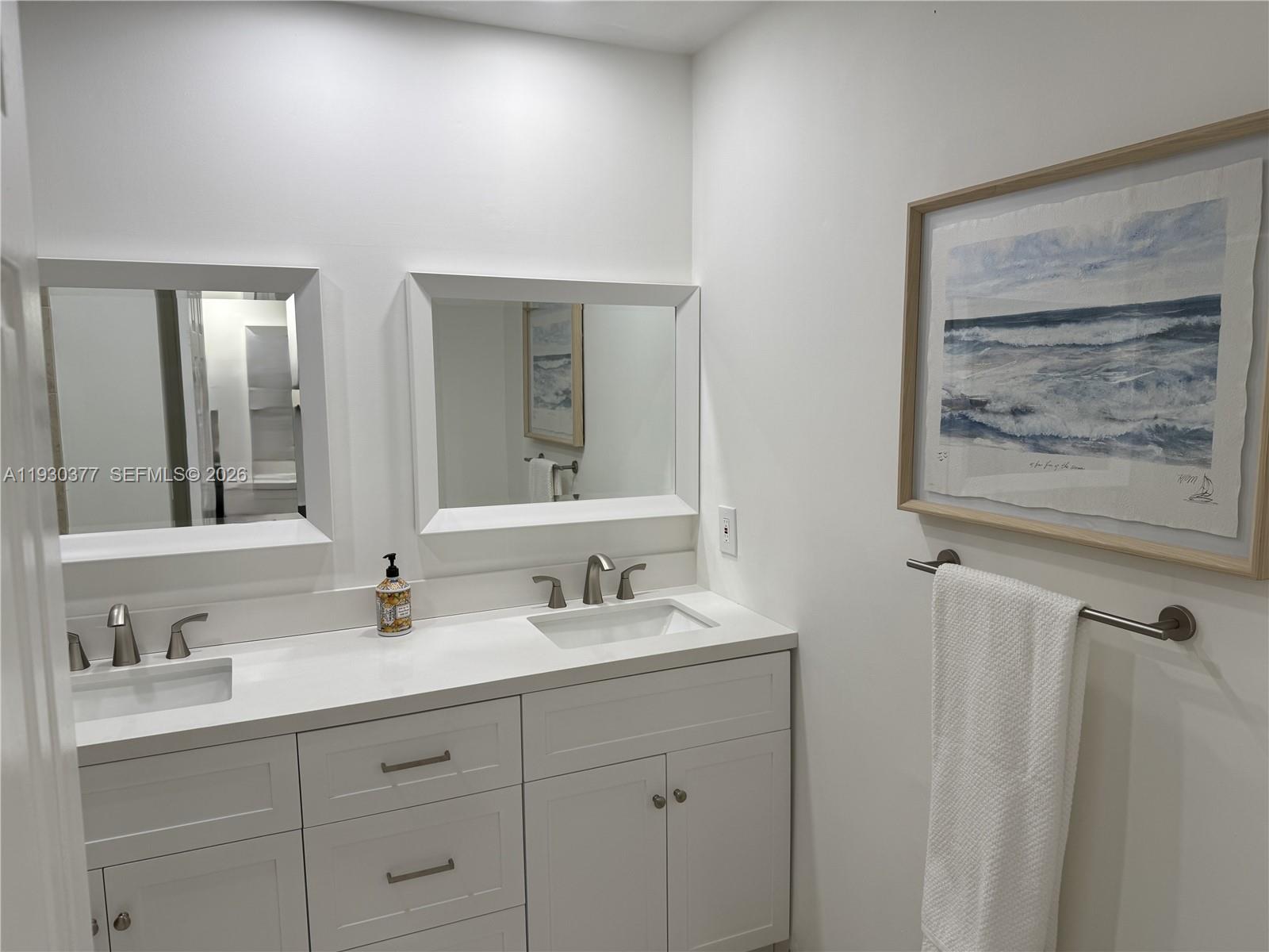 4161 South Us Highway, Unit K1 Jupiter, FL 33477 - Photo 16 of 49 a bathroom with double vanity sink and a mirror