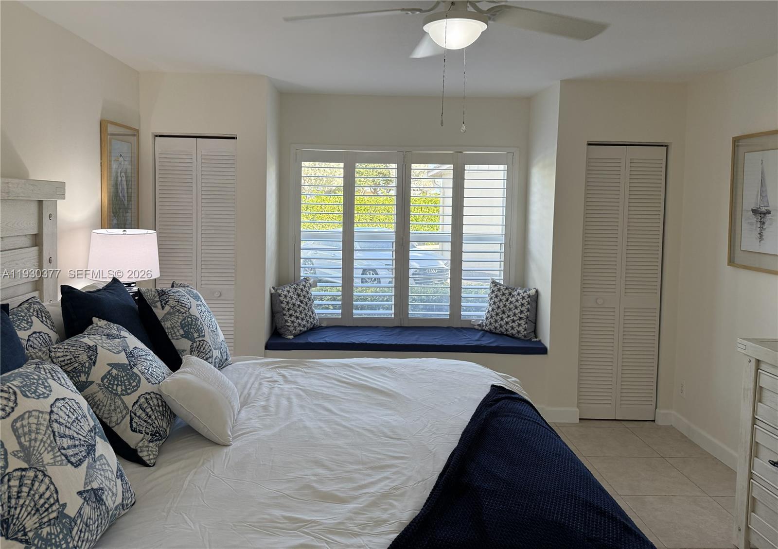 4161 South Us Highway, Unit K1 Jupiter, FL 33477 - Photo 18 of 49 a bed sitting in a bedroom next to a window