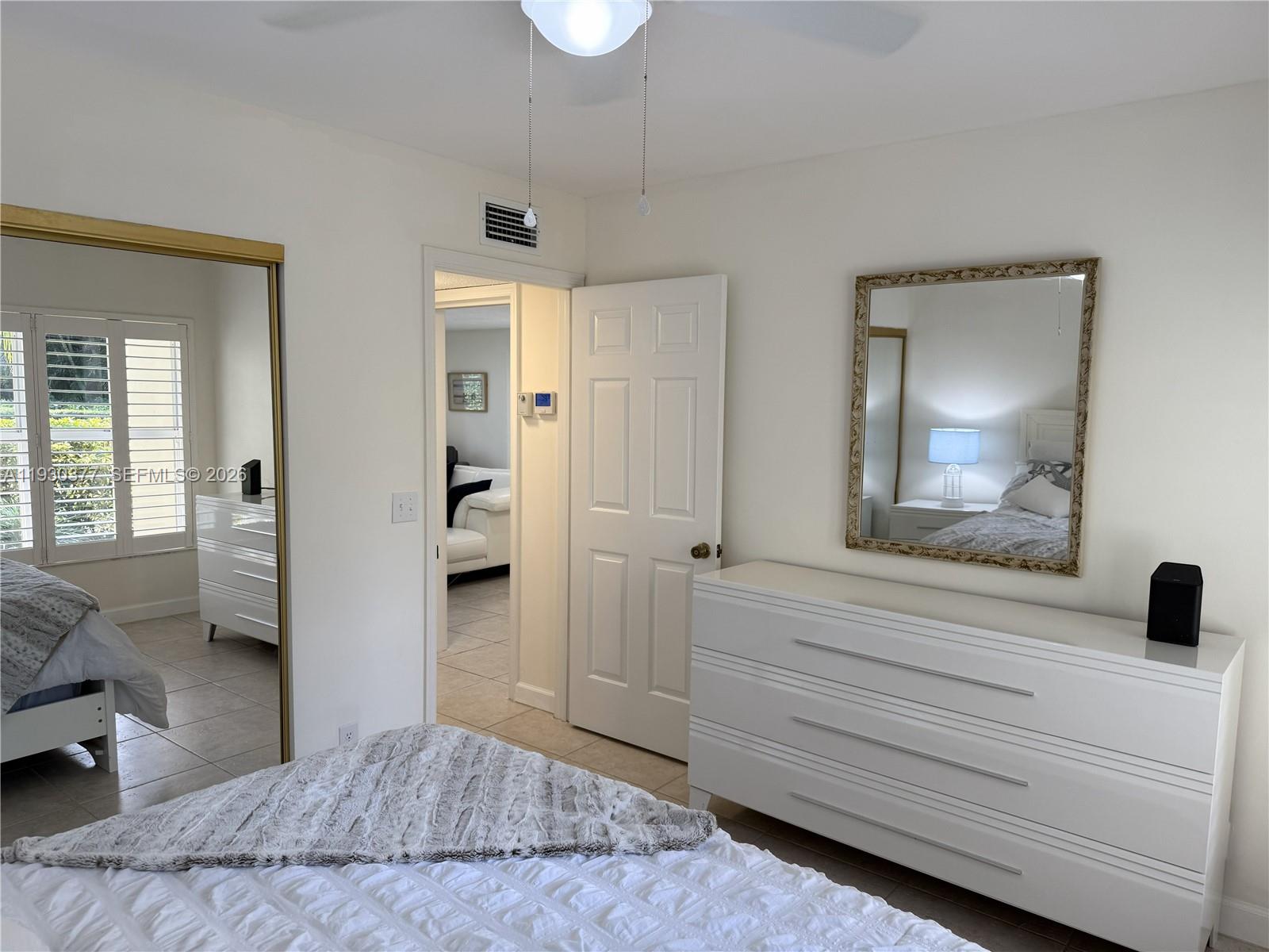 4161 South Us Highway, Unit K1 Jupiter, FL 33477 - Photo 22 of 49 a bedroom with a bed and a large mirror in it