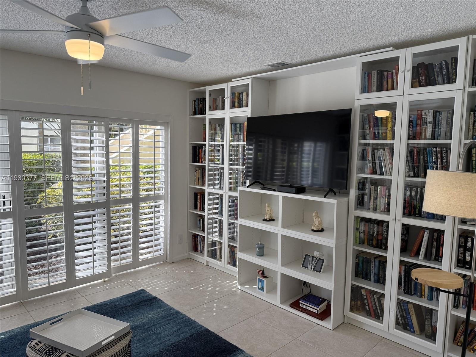 4161 South Us Highway, Unit K1 Jupiter, FL 33477 - Photo 27 of 49 a living room with a bookshelf and a window