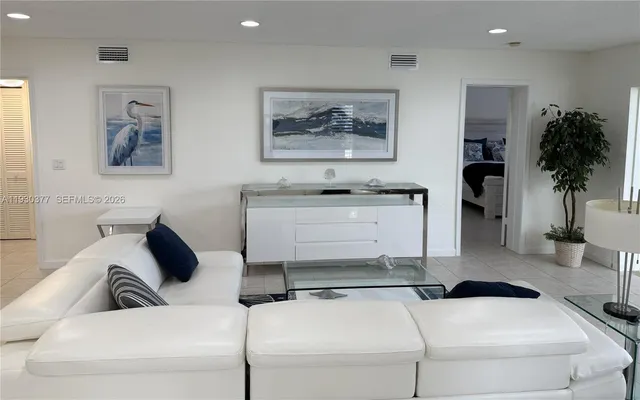 a view of a patio with table and chairs potted plants