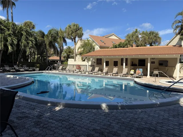 a front view of a house with a yard and a garage