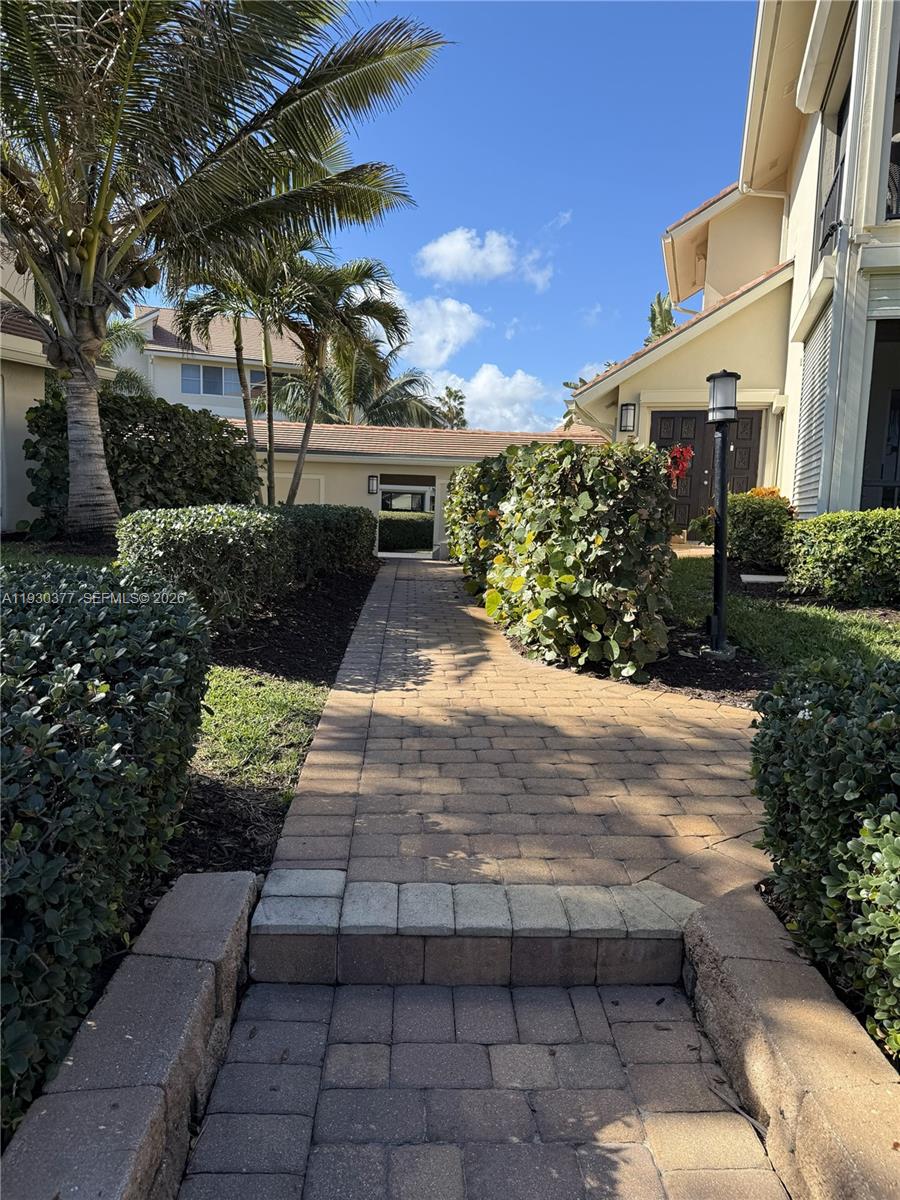 4161 South Us Highway, Unit K1 Jupiter, FL 33477 - Photo 45 of 49 a front view of a house with a yard and a garage