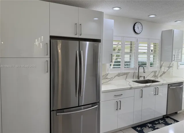 a kitchen with a sink cabinets and window