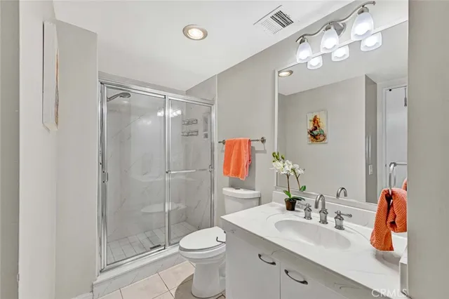 a bathroom with a sink vanity granite and toilet