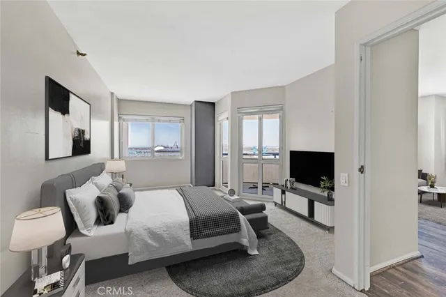 a bedroom with a bed and flat tv screen on the dresser
