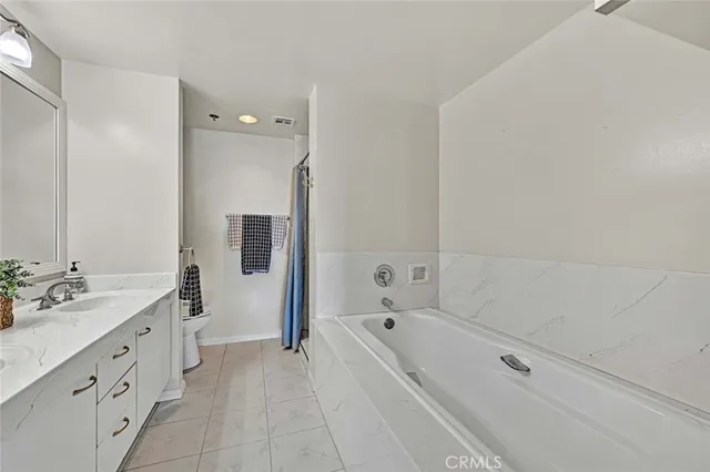 a bathroom with a tub sink and mirror