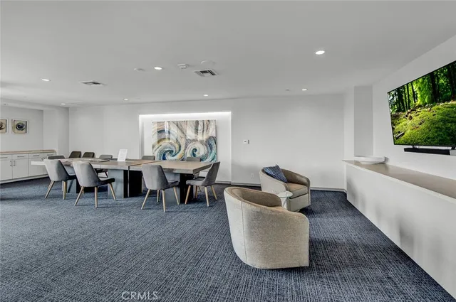 a living room with couches and a flat screen tv