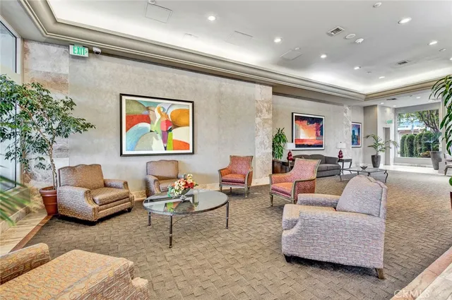 a living room with furniture and a potted plant