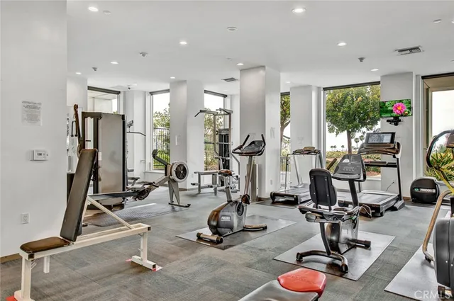 a room with gym equipment and windows
