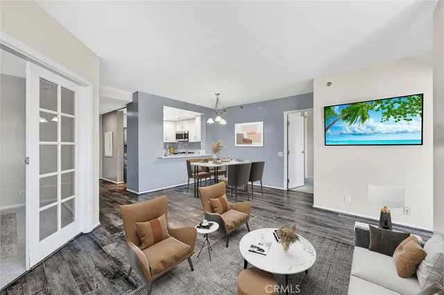 a living room with furniture and a dining table