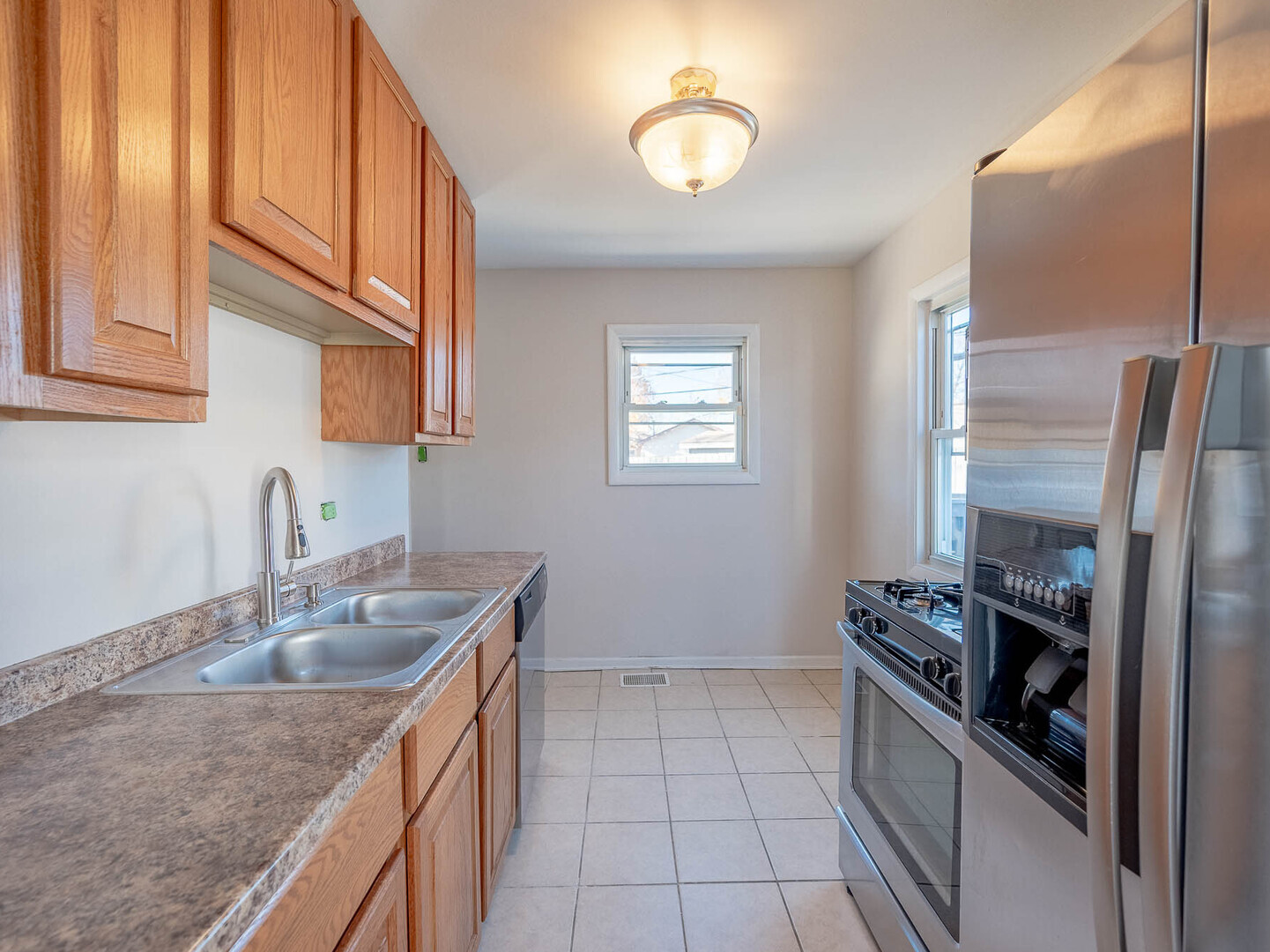 1621 Inner Cir Drive Crest Hill, IL 60403 - Photo 4 of 12 a kitchen that has a sink stainless steel appliances a counter space and a window