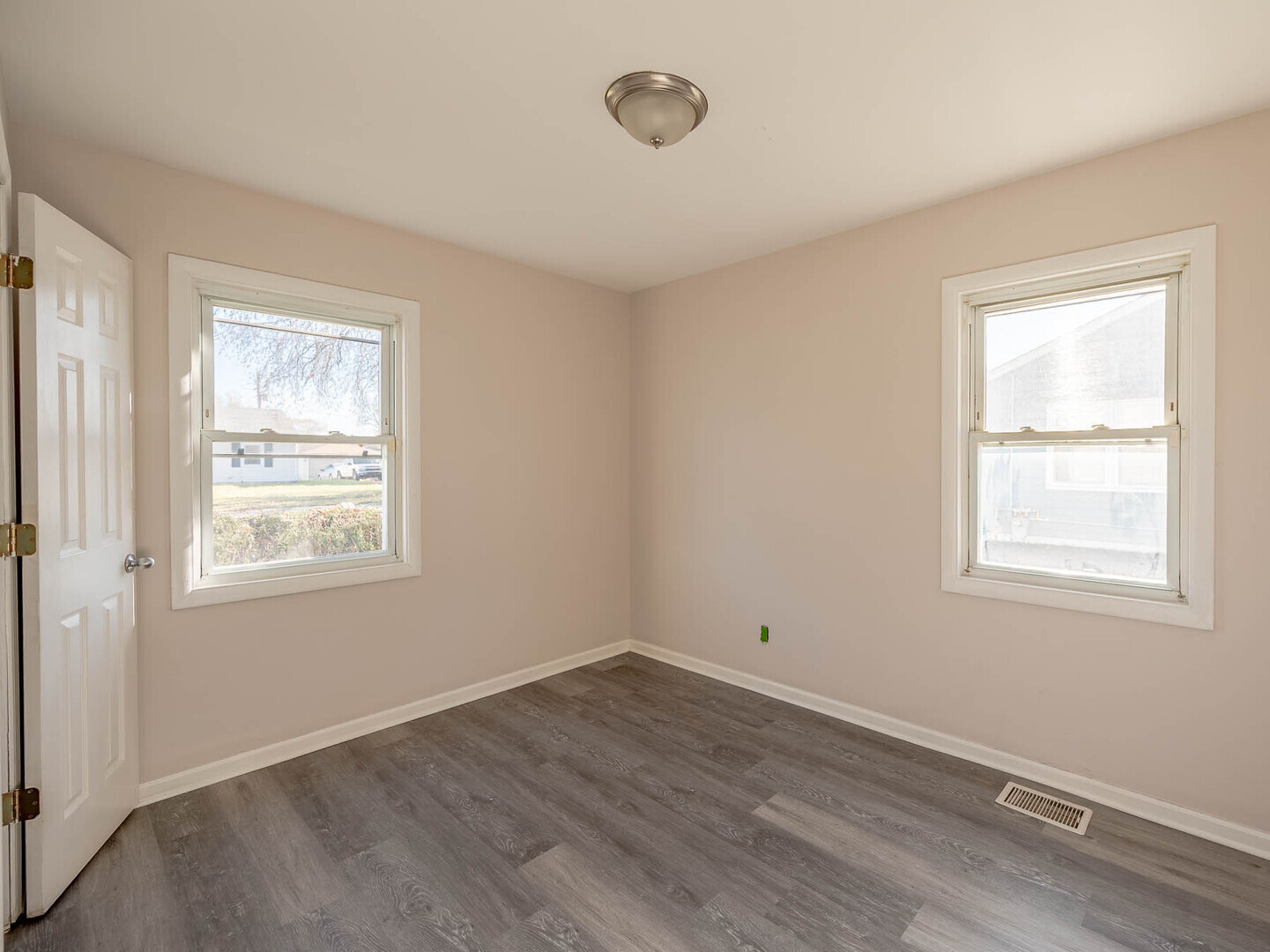 1621 Inner Cir Drive Crest Hill, IL 60403 - Photo 7 of 12 a view of an empty room with wooden floor and a window