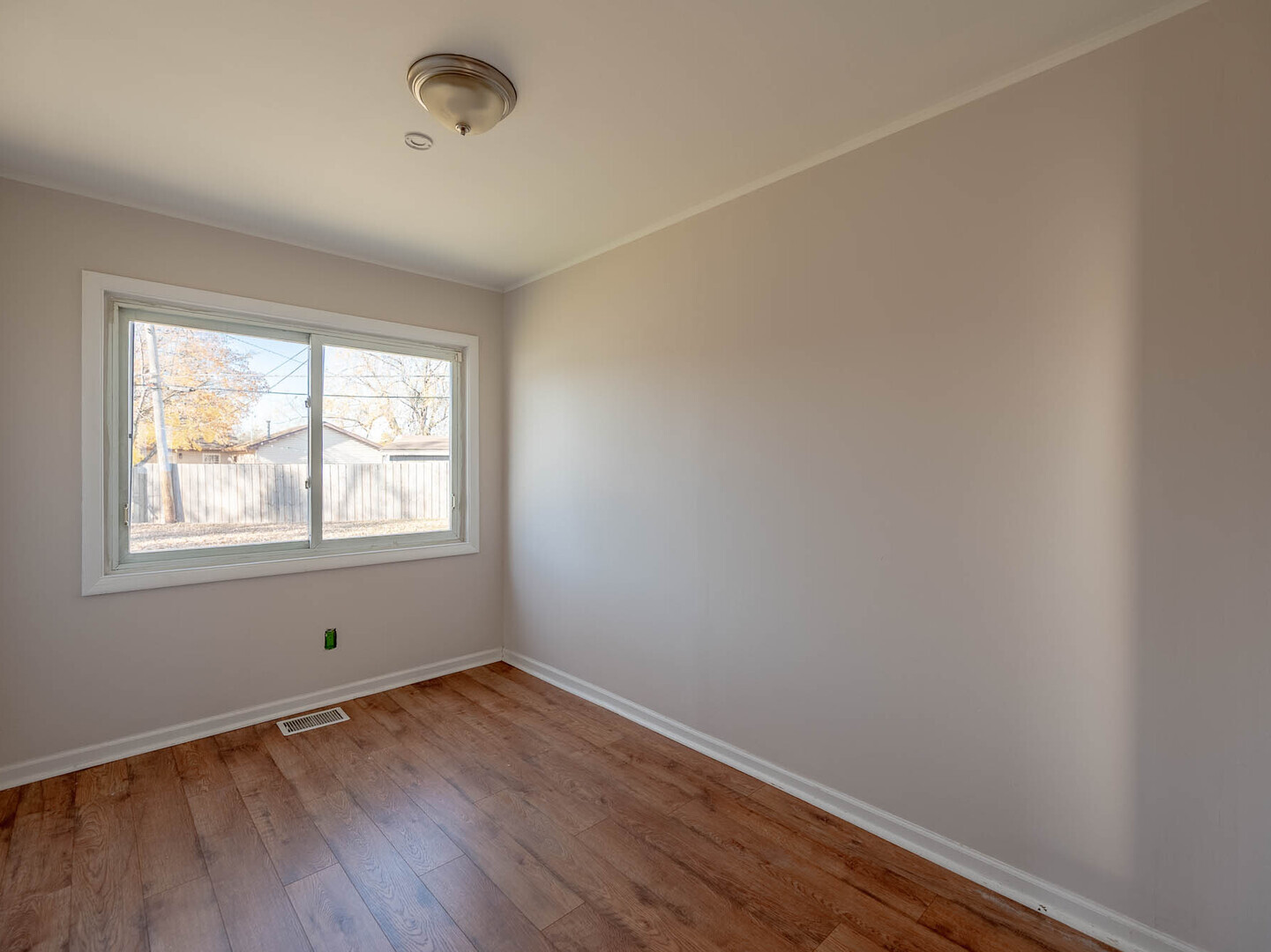 1621 Inner Cir Drive Crest Hill, IL 60403 - Photo 9 of 12 an empty room with wooden floor and windows