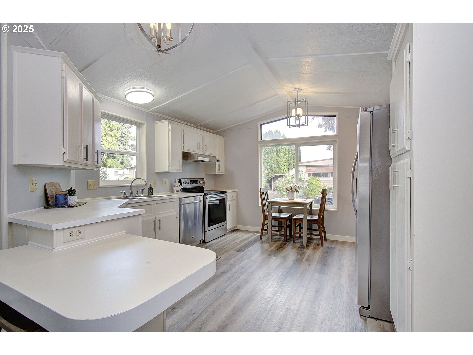 5404 Northeast 121st Avenue, Unit 98 Vancouver, WA 98682 - Photo 3 of 28 a open dining room with kitchen island furniture a large window and stainless steel appliances