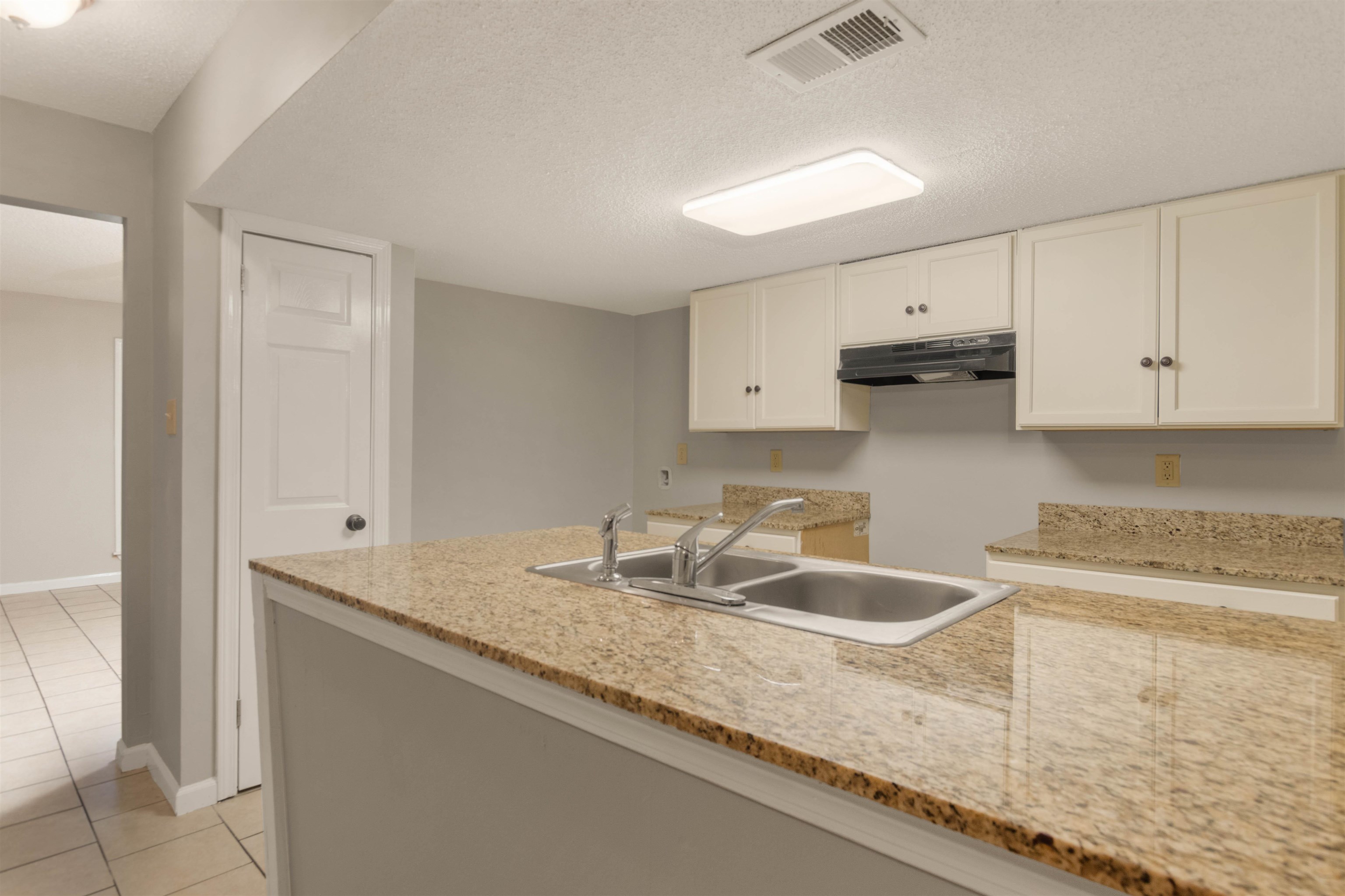 5573 Pleasant View Road, Unit 35 Memphis, TN 38134 - Photo 6 of 25 a kitchen with granite countertop white cabinets and a sink