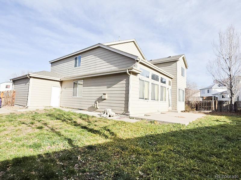 20420 Kelly Place Denver, CO 80249 - Photo 21 of 21 a front view of a house with a garden and yard