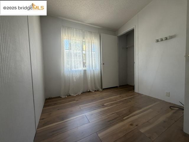 14192 Tuolumne Road, Unit 5 Sonora, CA 95370 - Photo 7 of 10 an empty room with wooden floor and windows