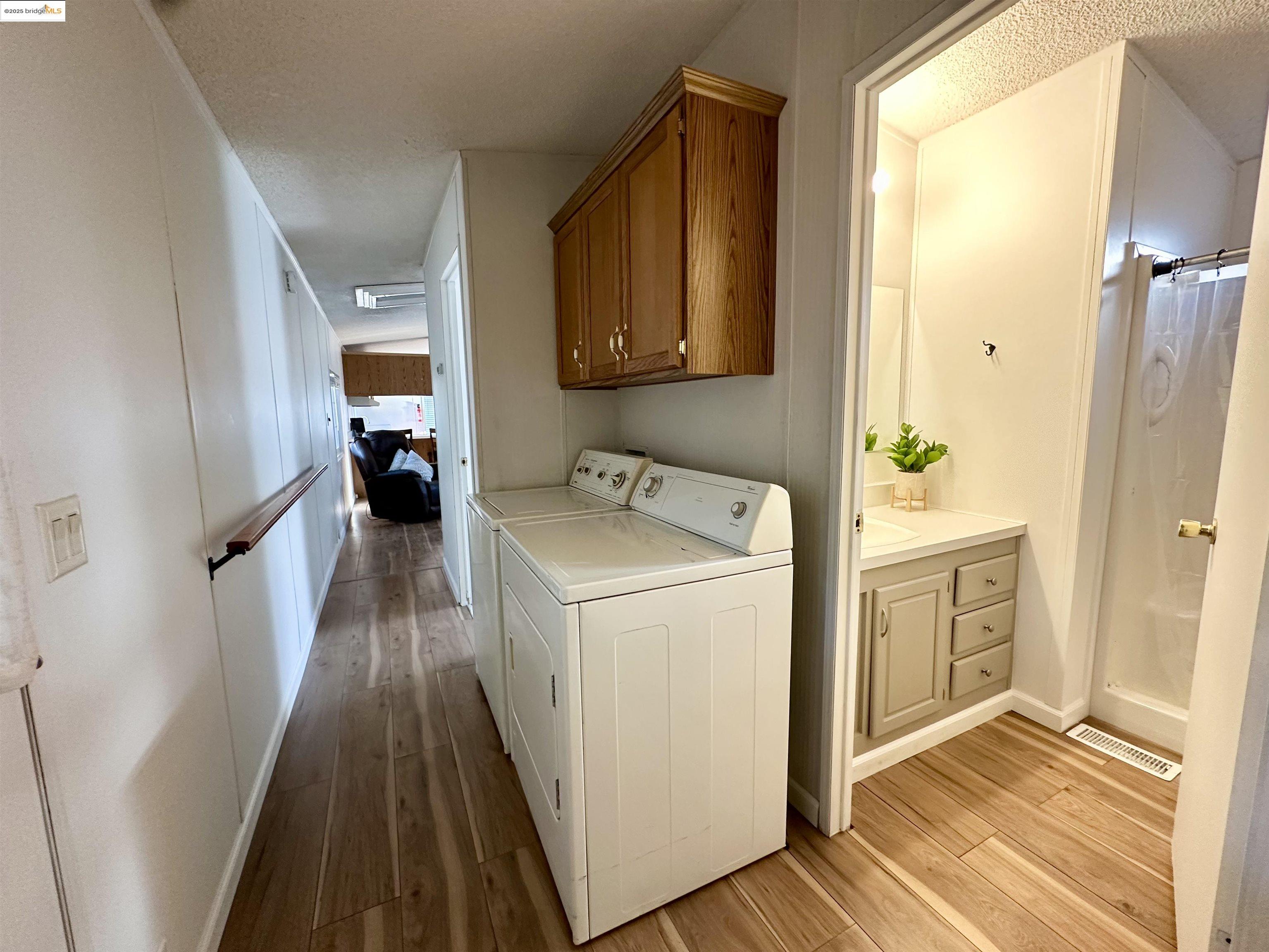 14192 Tuolumne Road, Unit 5 Sonora, CA 95370 - Photo 7 of 12 a hallway view with wooden floor washer and dryer