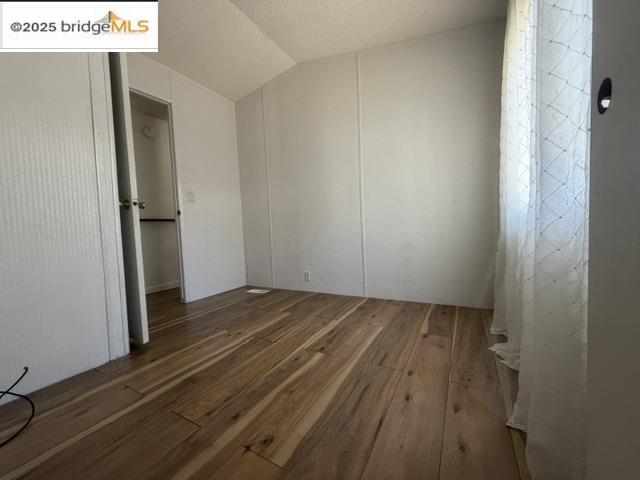 14192 Tuolumne Road, Unit 5 Sonora, CA 95370 - Photo 8 of 10 an empty room with wooden floor
