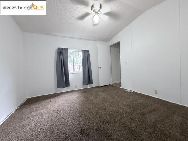 14192 Tuolumne Road, Unit 5 Sonora, CA 95370 - Photo 9 of 10 an empty room with windows and ceiling fan