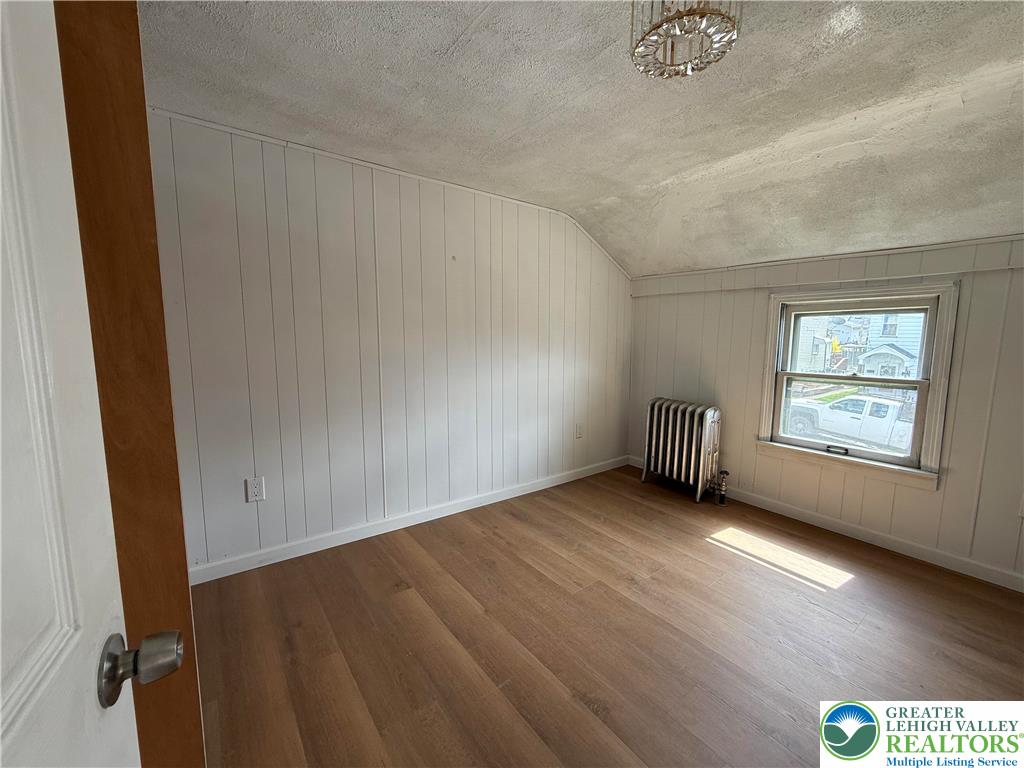 619 Hickory Street Scranton, PA 18505 - Photo 12 of 28 an empty room with wooden floor and windows