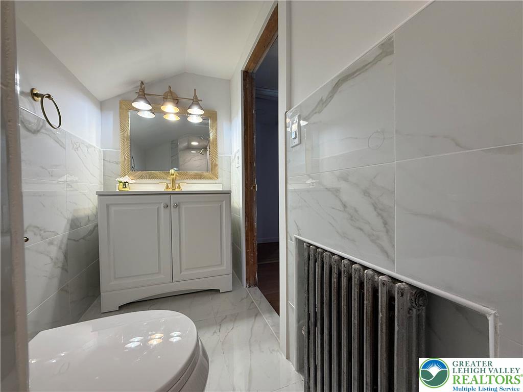 619 Hickory Street Scranton, PA 18505 - Photo 18 of 28 a bathroom with a sink a vanity and mirror