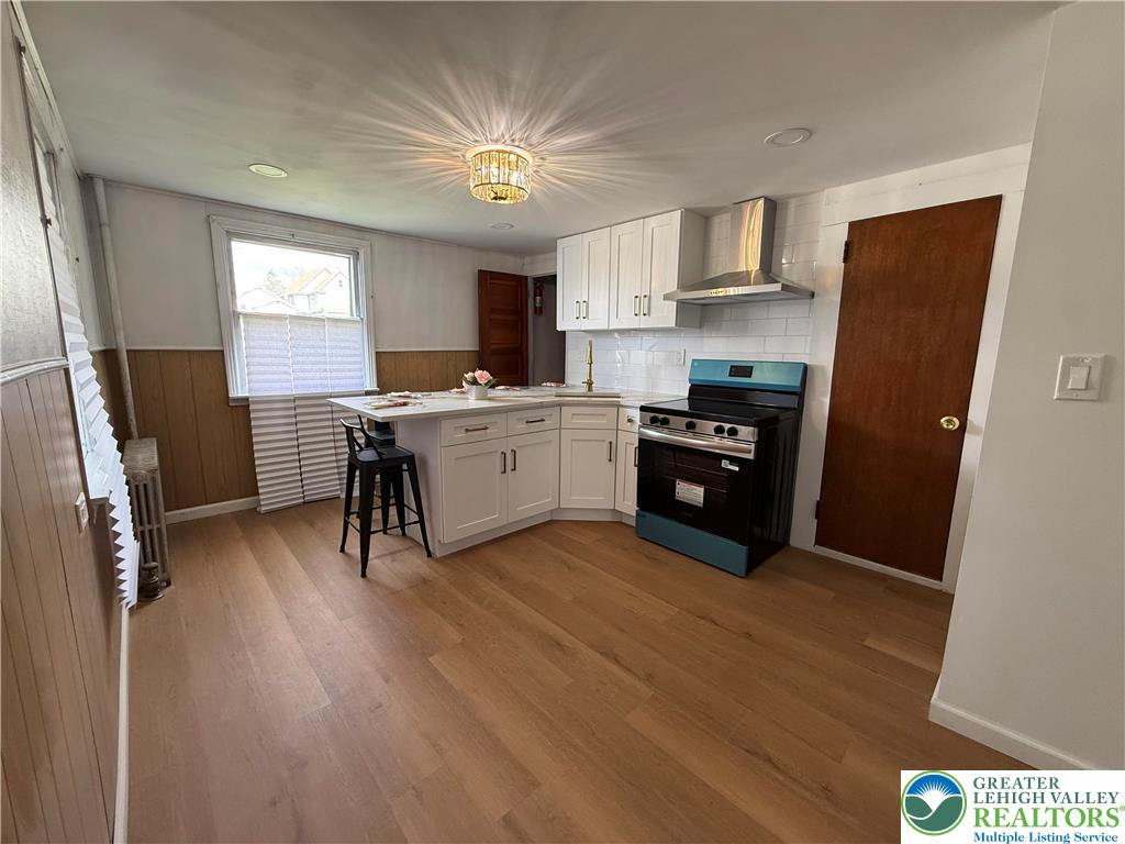 619 Hickory Street Scranton, PA 18505 - Photo 7 of 28 a kitchen with a refrigerator a sink dishwasher and a stove with wooden floor