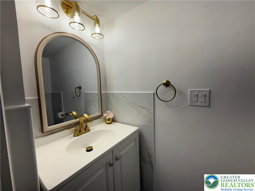 619 Hickory Street Scranton, PA 18505 - Photo 9 of 28 a bathroom with a sink and mirror