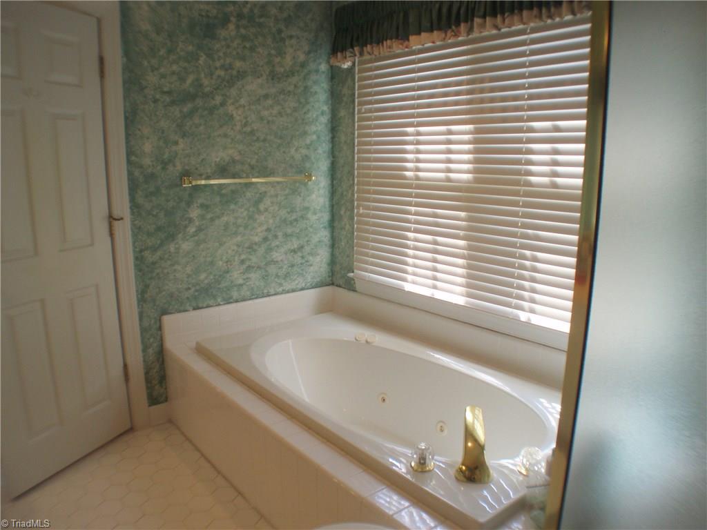 5802 Fleming Terrace Road Greensboro, NC 27410 - Photo 15 of 26 A nice jetted tub is a feature in the master bath suite.