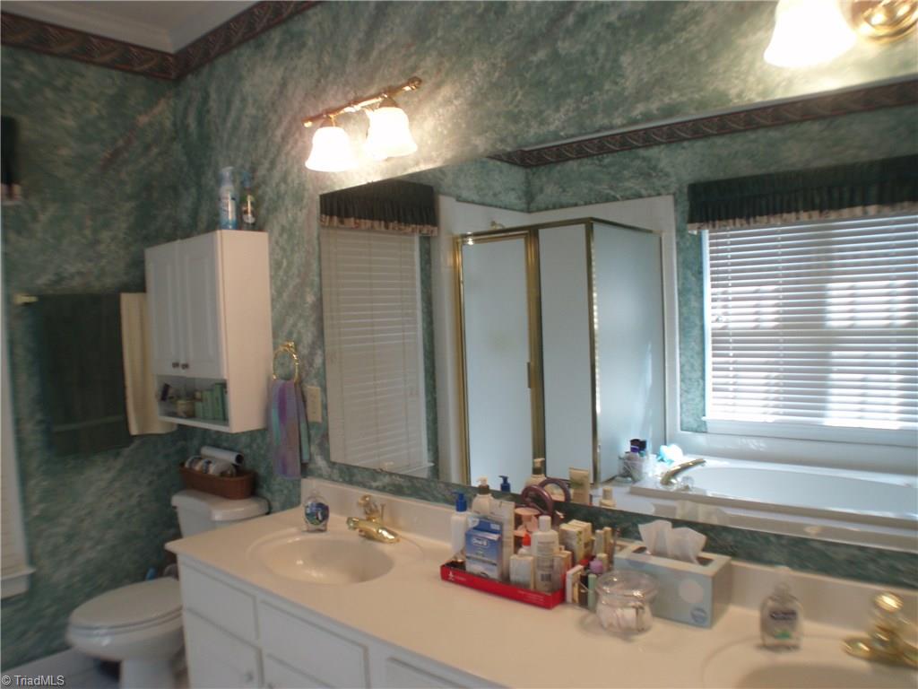 5802 Fleming Terrace Road Greensboro, NC 27410 - Photo 17 of 26 Double sinks, spacious counter top and plenty of storage are other great features of the master bath.