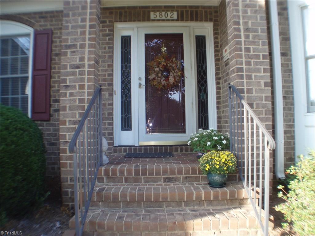 5802 Fleming Terrace Road Greensboro, NC 27410 - Photo 3 of 26 Beautiful entry is accented by double side-lighted door.
