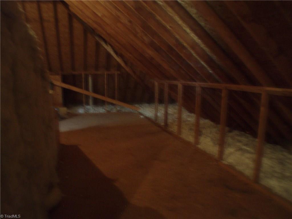 5802 Fleming Terrace Road Greensboro, NC 27410 - Photo 24 of 26 This is only a small portion of the unfinished attic. There is a great deal more that is being used for storage. There are permanent stairs up to this area.