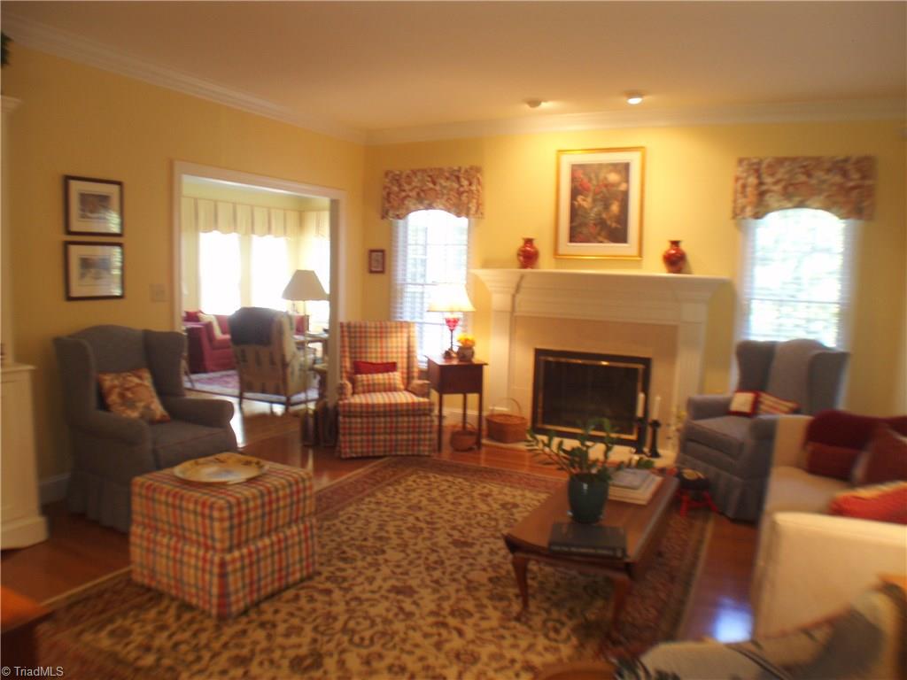 5802 Fleming Terrace Road Greensboro, NC 27410 - Photo 5 of 26 The living room is anchored by a gas log fireplace and features beautiful crown molding and gleaming hardwood floors. It is large enough to provide many seating options but small enough to feel cozy.