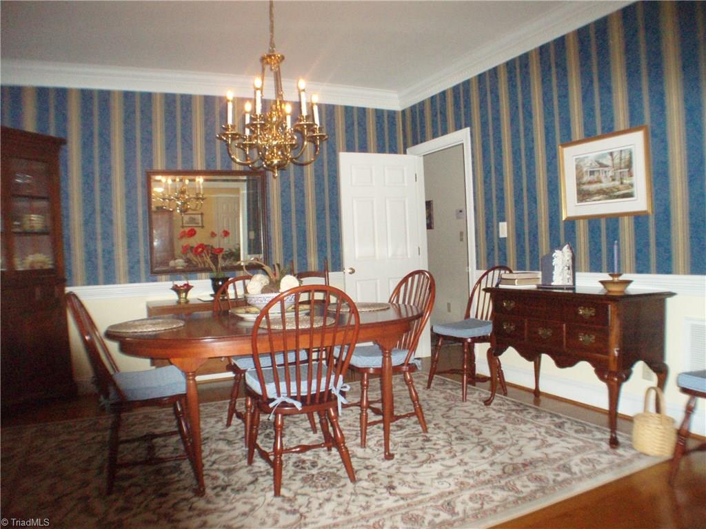 5802 Fleming Terrace Road Greensboro, NC 27410 - Photo 7 of 26 The formal dining room is gracious and large enough to accommodate a full dining suite.