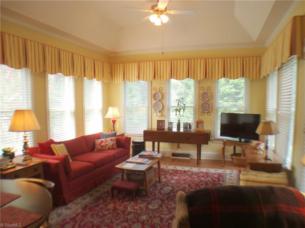 5802 Fleming Terrace Road Greensboro, NC 27410 - Photo 8 of 26 The sun room features a high trey ceiling, hardwoods, and access to a pretty patio. The sun room connects the breakfast area and the kitchen.