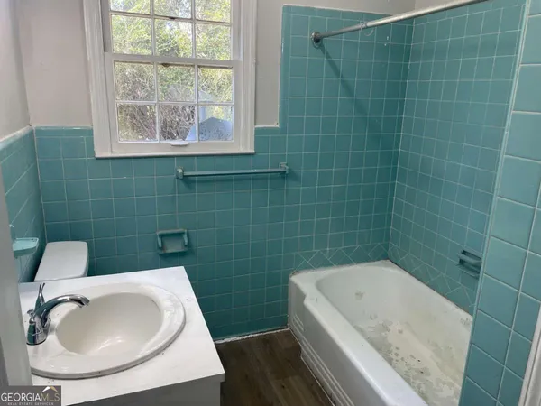 a bathroom with a sink a toilet and bathtub