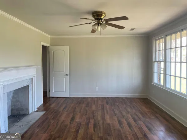 wooden floor in an empty room with a window