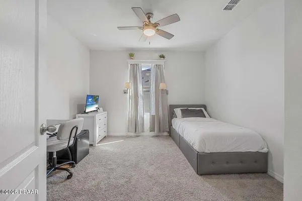 a bedroom with a bed and a table in it