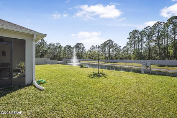 a view of a swimming pool with an outdoor seating and a yard