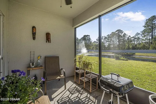 a view of a chairs and table in patio with a lake view