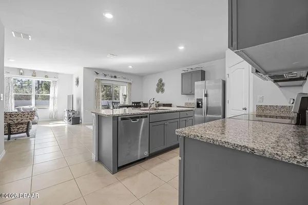 a kitchen with stainless steel appliances granite countertop a stove and a sink
