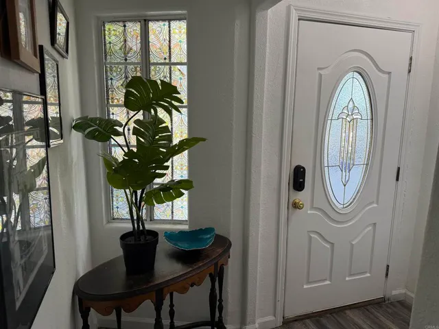 a vase of flowers sitting on a table near a window