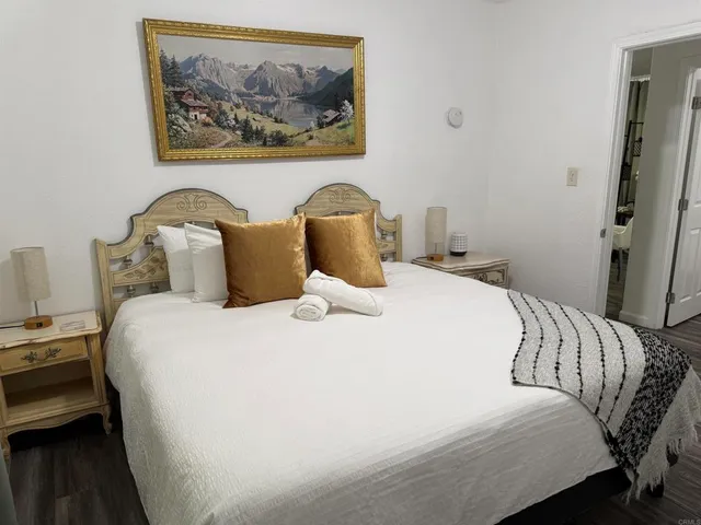 a bedroom with a bed and a painting on the wall