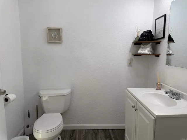 a bathroom with a toilet a sink and vanity