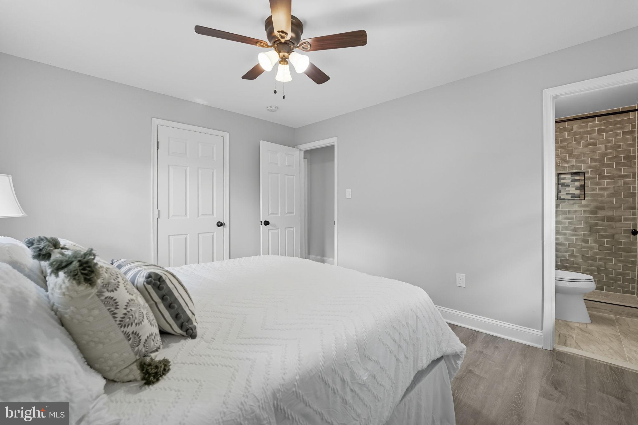 3708 Woodridge Avenue Silver Spring, MD 20902 - Photo 14 of 38 a bedroom with a bed and a chandelier