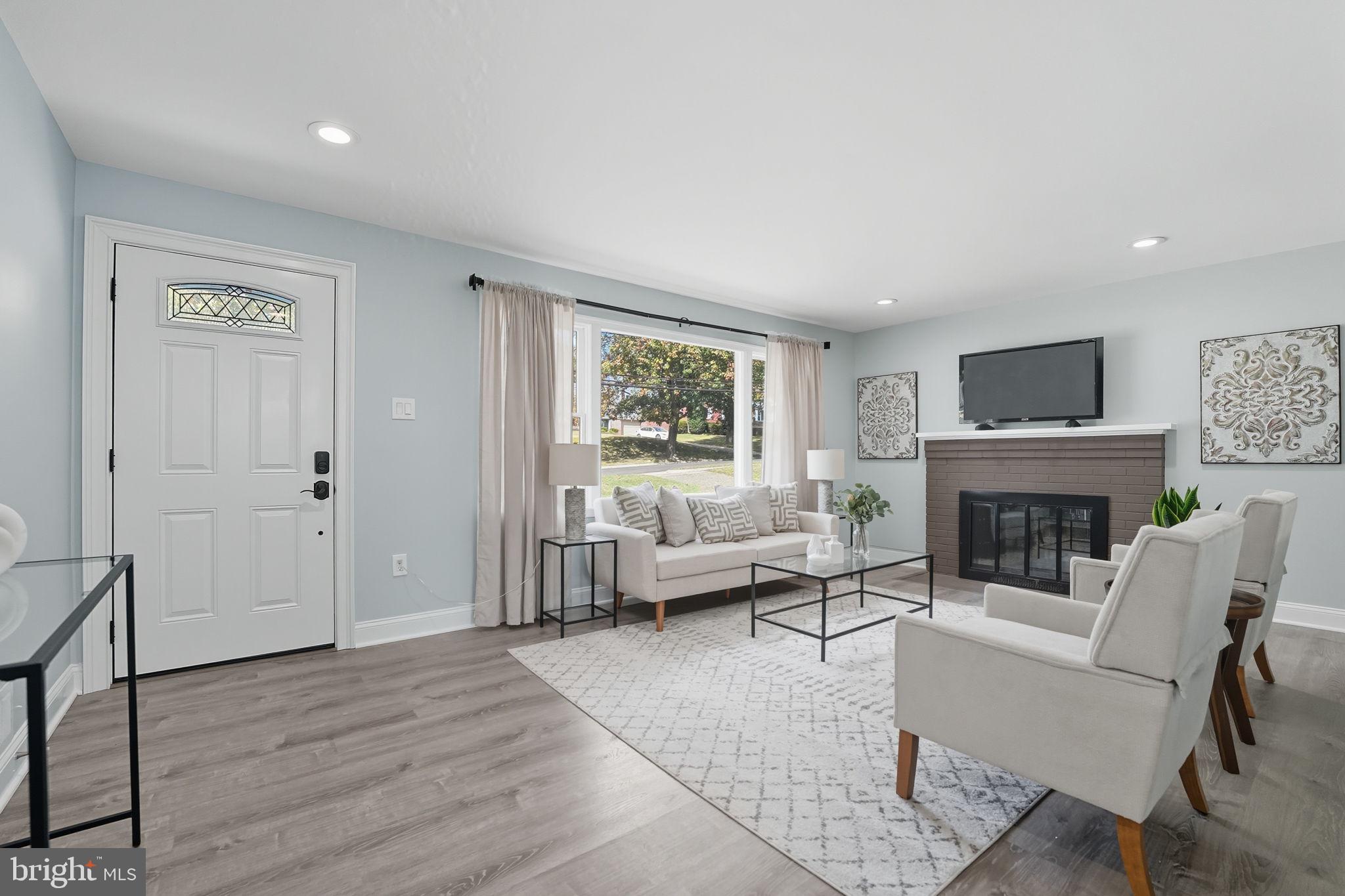 3708 Woodridge Avenue Silver Spring, MD 20902 - Photo 2 of 38 a living room with furniture a fireplace and a window