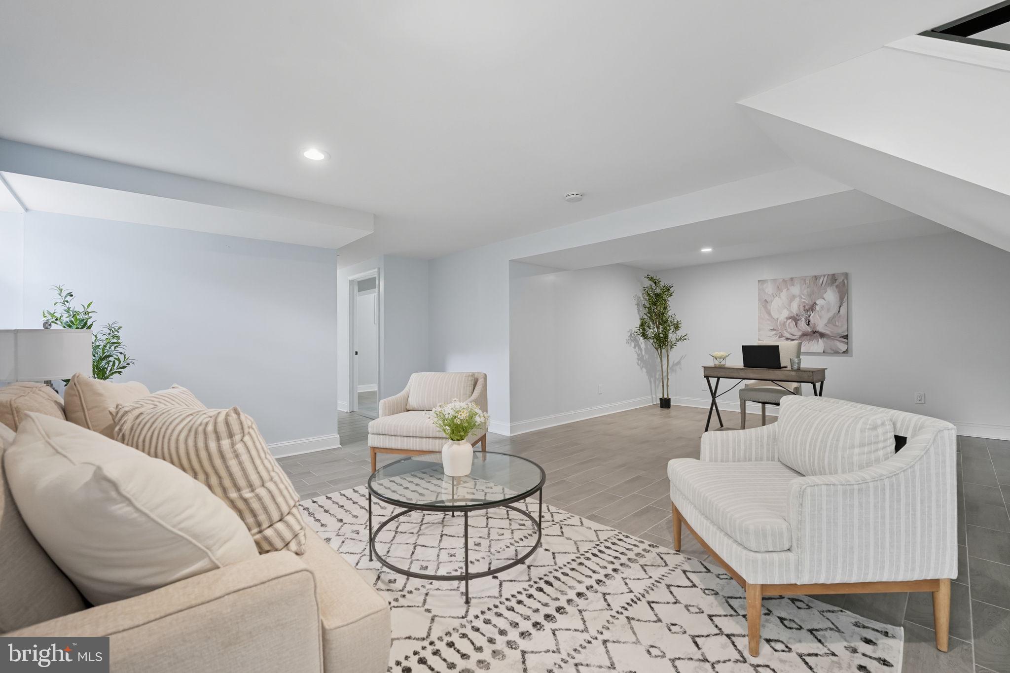 3708 Woodridge Avenue Silver Spring, MD 20902 - Photo 24 of 38 a living room with furniture and a dining table with wooden floor