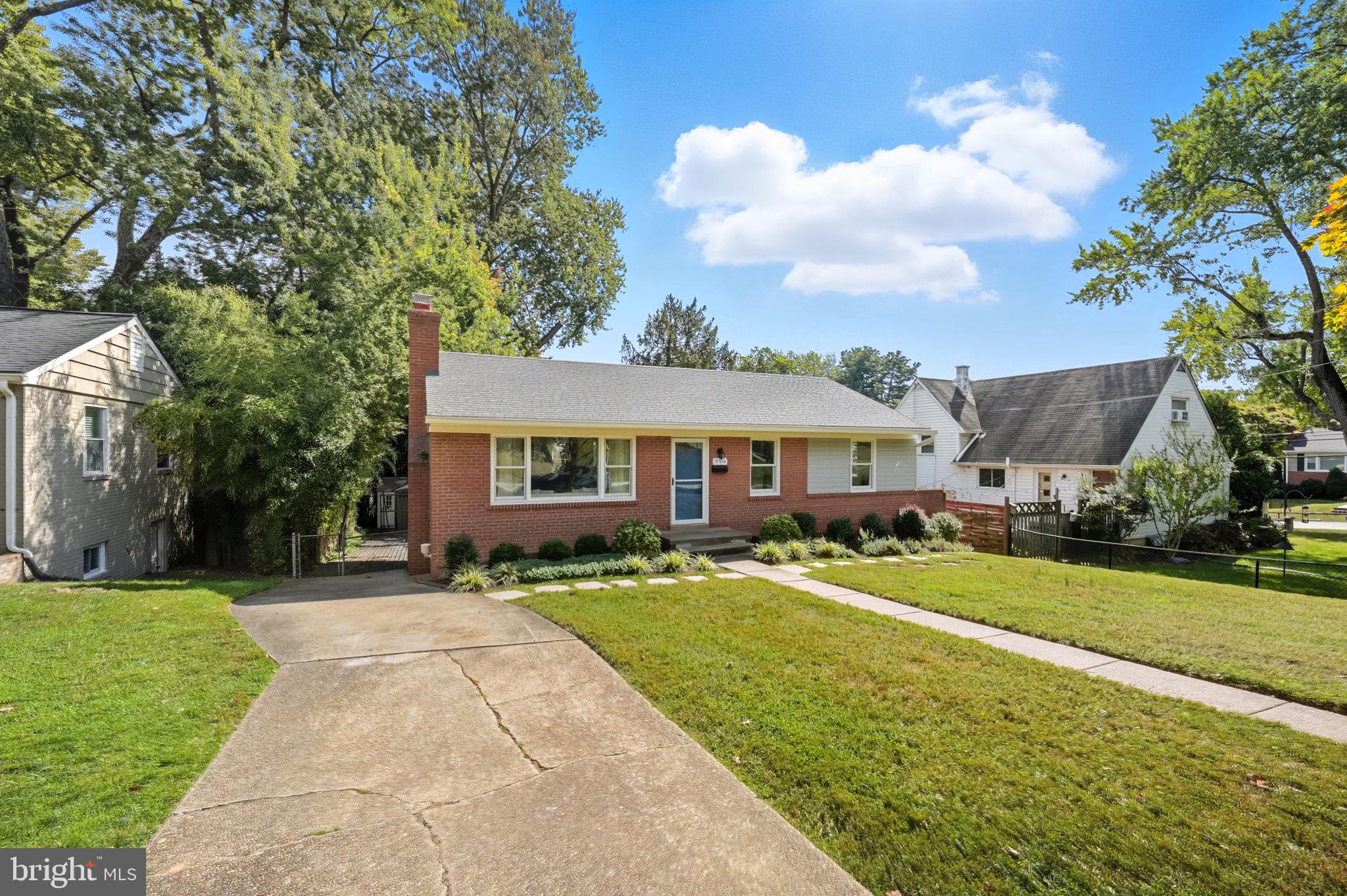 3708 Woodridge Avenue Silver Spring, MD 20902 - Photo 35 of 38 a front view of a house with a garden and trees